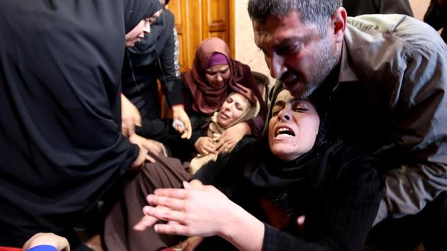 Relatives of Palestinian teenager Fahed Al-Astal who was killed near the border fence, mourn during his funeral in the southern Gaza Strip. (Ibraheem Abu Mustafa / REUTERS)
