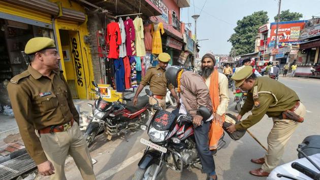 Policemen conduct search of a motorcyclist at a barricade, as part of security measures on the eve of the 27th anniversary of the Babri Masjid demolition, near Hanumangarhi area in Ayodhya. (PTI) Policemen conduct search of a motorcyclist at a barricade, as part of security measures on the eve of the 27th anniversary of the Babri Masjid demolition, near Hanumangarhi area in Ayodhya. (PTI)