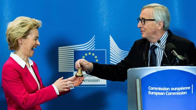 Outgoing European Commission President Jean-Claude Juncker (R) gives a bell to new European Commission President Ursula von der Leyen as he delivers a speech during the handing-over ceremony at the European Union’s headquarters, in Brussels, Belgium. (Kenzo Tribouillard / AFP)