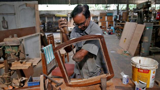A man, who has lost his left forearm in an accident, makes a wooden chair inside a training centre for disabled people on the occasion of International Day of Disabled Persons, in Ahmedabad, Gujarat. (Amit Dave / REUTERS) A man, who has lost his left forearm in an accident, makes a wooden chair inside a training centre for disabled people on the occasion of International Day of Disabled Persons, in Ahmedabad, Gujarat. (Amit Dave / REUTERS)
