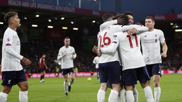 Liverpool's Mohamed Salah (11) celebrates with teammates.(AP)