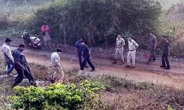 Police at the site of the alleged encounter of the four accused in the rape and murder of a veterinary on the outskirts of Hyderabad on Friday morning.(PTI PHOTO.)