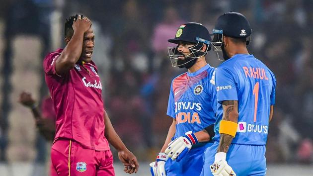 India's skipper Virat Kohli and West Indies bowler talk as batsman KL Rahul looks on.(PTI) India's skipper Virat Kohli and West Indies bowler talk as batsman KL Rahul looks on.(PTI)