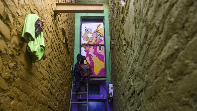 A boy climbs up a ladder to enter a home adorned with a mural painted by artists from '’Delhi Street Art’ group at the Raghubir Nagar slum in New Delhi. (Sajjad Hussain / AFP) A boy climbs up a ladder to enter a home adorned with a mural painted by artists from '’Delhi Street Art’ group at the Raghubir Nagar slum in New Delhi. (Sajjad Hussain / AFP)