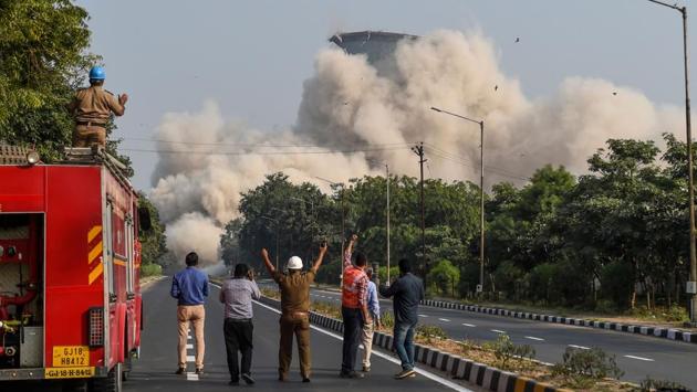 Rescue workers react as the second of India’s highest 118-meter twin cooling towers of Gujarat State Thermal Power Station starts to collapse during a demolition on the outskirts of Gandhinagar some 40 kms from Ahmedabad, Gujarat. (Sam Panthaky / AFP) Rescue workers react as the second of India’s highest 118-meter twin cooling towers of Gujarat State Thermal Power Station starts to collapse during a demolition on the outskirts of Gandhinagar some 40 kms from Ahmedabad, Gujarat. (Sam Panthaky / AFP)