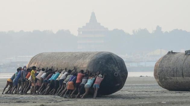 Labourers push a pontoon buoy in the banks of the river Ganga as they build a floating bridge for the upcoming Hindu festival of Magh Mela, in Prayagraj, Uttar Pradesh. (Sanjay Kanojia / AFP) Labourers push a pontoon buoy in the banks of the river Ganga as they build a floating bridge for the upcoming Hindu festival of Magh Mela, in Prayagraj, Uttar Pradesh. (Sanjay Kanojia / AFP)
