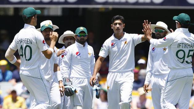 File image: Pakistan's Naseem Shah, center, celebrates with his team after getting the wicket of Australia's David Warner during their cricket test match in Brisbane.(AP)