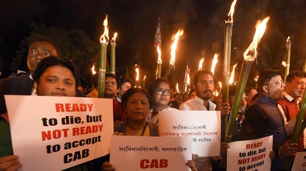 People take part in torchlight protest rally against the Citizenship (Amendment) Bill in Guwahati on Saturday.(ANI)