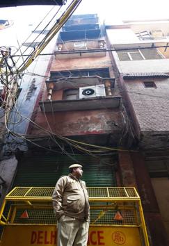 A policeman stands near a building in north Delhi’s Anaj Mandi where 43 people were killed in a fire on Sunday. (Amal KS/HT photo) A policeman stands near a building in north Delhi’s Anaj Mandi where 43 people were killed in a fire on Sunday. (Amal KS/HT photo)