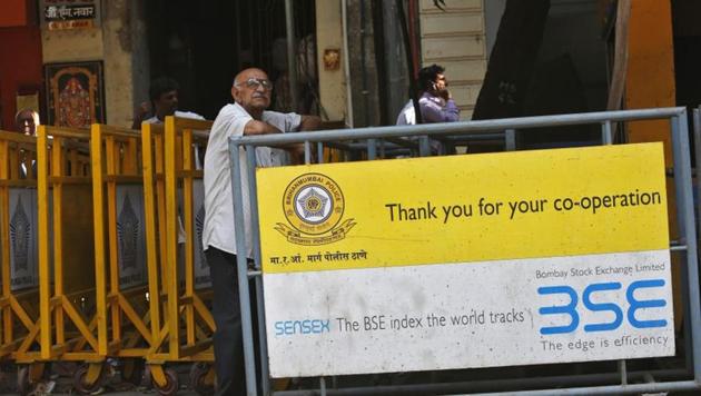 A man looks at a screen across the road displaying the Sensex on the facade of the Bombay Stock Exchange (BSE) building in Mumbai (Reuters File) A man looks at a screen across the road displaying the Sensex on the facade of the Bombay Stock Exchange (BSE) building in Mumbai (Reuters File)