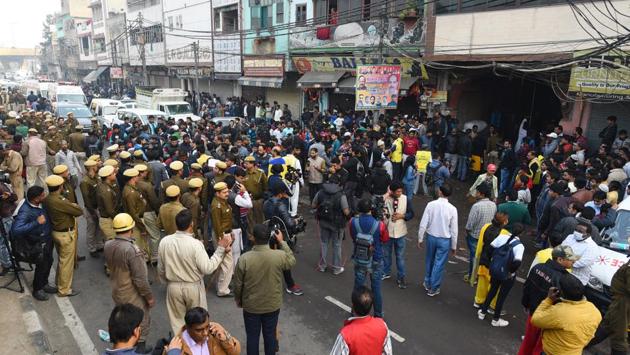 Local residents said they were woken up on the misty winter morning by screams of people clamouring to be rescued from the fire around 4 am but didn’t realise the fire had trapped the workers, who were between 13 and 27 and hailed from impoverished districts in Bihar and UP. An hour had passed before plumes of smoke alerted locals. By the time the fire services received a call at 5:22 am, hundreds had gathered around the blazing building. (Sanchit Khanna / HT Photo)