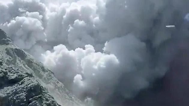 Thick smoke from the volcanic eruption of Whakaari, also known as White Island, is seen in New Zealand, December 9, 2019, in this image obtained via social media.(@SCH VIA REUTERS)