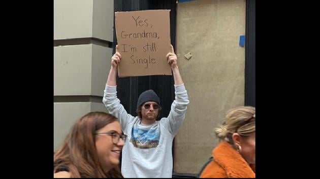 “If you don’t stand for something, you’ll fall for anything,” says the profile bio.(Instagram/@dudewithsign)