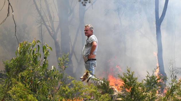 A resident looks on as vegetation on his property is set ablaze in back burning measures to secure residential areas from encroaching bushfires, at the Mangrove area in Central Coast. In the small city of Hawkesbury, about 50 km (31.1 miles) north west of Sydney, residents joined firefighters to safeguard their properties. Mayor Barry Calvert said residents were trying to clear foliage from around their homes, and opening gates to ensure emergency workers have access. (SAEED KHAN / AFP) A resident looks on as vegetation on his property is set ablaze in back burning measures to secure residential areas from encroaching bushfires, at the Mangrove area in Central Coast. In the small city of Hawkesbury, about 50 km (31.1 miles) north west of Sydney, residents joined firefighters to safeguard their properties. Mayor Barry Calvert said residents were trying to clear foliage from around their homes, and opening gates to ensure emergency workers have access. (SAEED KHAN / AFP)