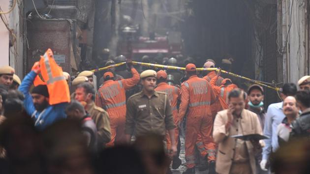 National Disaster Response Force (NDRF) personnel deployed at the spot where a fire broke out in a plastic factory, at Anaj Mandi, Filmistan, in New Delhi(Sanchit Khanna/HT PHOTO)