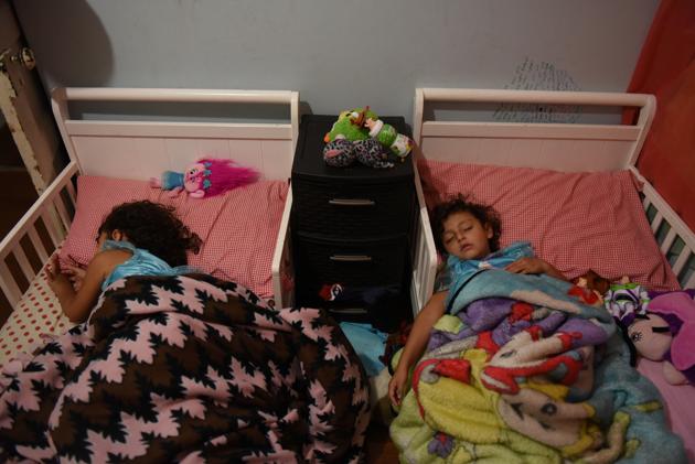 Zayleeana Tiemann, who recently turned 3, and her sister Zoey, 4, sleep before their first day of school. After Garcia’s death, Tiemann had to step into an unfamiliar role, one he said he was not prepared for. “I buy products for their hair, I buy little rubber bands,” he said. “I’ve tried to paint their nails sometimes.” The feeling of inadequacy weighs on him daily. (Callaghan O'Hare / REUTERS) Zayleeana Tiemann, who recently turned 3, and her sister Zoey, 4, sleep before their first day of school. After Garcia’s death, Tiemann had to step into an unfamiliar role, one he said he was not prepared for. “I buy products for their hair, I buy little rubber bands,” he said. “I’ve tried to paint their nails sometimes.” The feeling of inadequacy weighs on him daily. (Callaghan O'Hare / REUTERS)