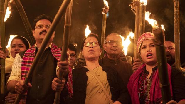 Activists participate in a torch light procession to protest against the Citizenship Amendment Bill (CAB) in Gauhati.(AP)