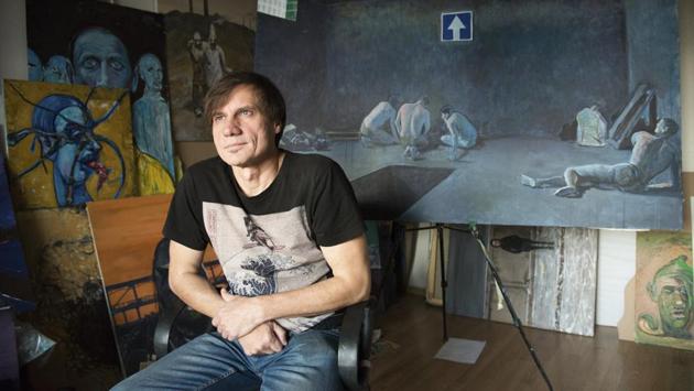 Serhii Zakharov, former resident of Donetsk, poses in his apartment, which he uses as a drawing studio in Kyiv. Zakharov was detained in Donetsk by pro-Russia militias in August 2014, unhappy with his caricatures on them, and continued to draw sketches for the whole month he had spent in captivity. Armed groups from both sides of the conflict held them in underground dungeons and often used them to extort ransom from or somehow leverage the other side. Hundreds of people still remain locked up. (Zoya Shu / AP)