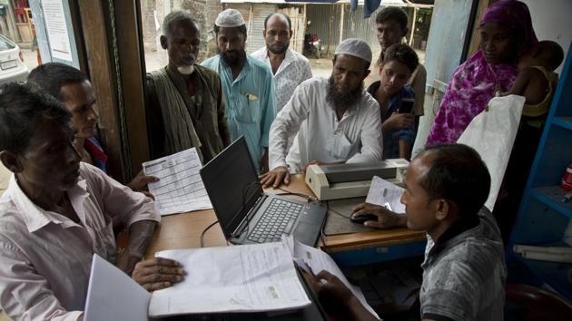 Villagers checking their names in the final list of the National Register of Citizens (NRC) in Assam’s Morigaon district.(AP Photo)