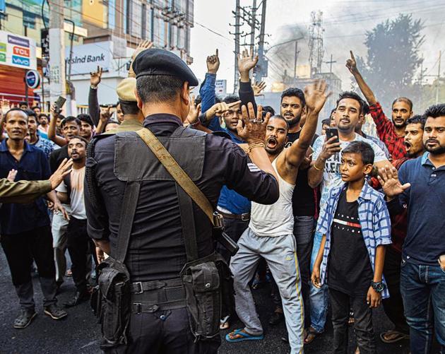 An Indian commando tries to stop as protesters block traffic during a shutdown protest against the Citizenship Amendment Bill (CAB) in Gauhati, Tuesday on December 10.(Photo: AP)