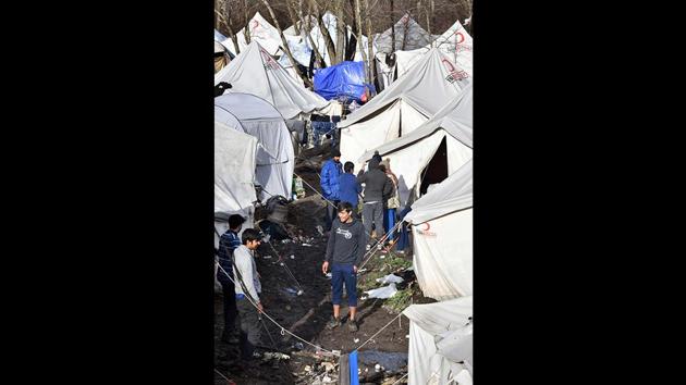 Illegal migrants walk among tents at the Vucjak camp. The impoverished country has become a key stop on a migrant route that runs through the Balkans to Western Europe. While most migrants eventually move on, Croatian police push many back at least temporarily, leaving them stuck in Bosnia for long periods of time. (Elvis Barukcic / AFP)