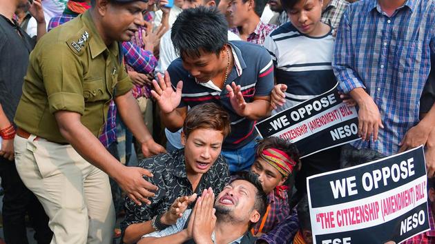 A man requesting police officer as he is being detained during a protest against the Citizenship Amendment Bill (CAB), in Agartala on Dec 11, 2019. (ANI Photo)