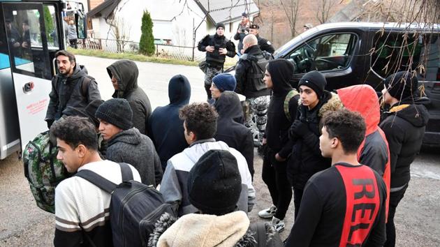 Illegal migrants wait to board buses, after leaving the makeshift camp. The decision to close the site came after Dunja Mijatovic, Council of Europe Commissioner for Human Rights, visited last week and warned of potential deaths if the camp was not closed immediately, especially as temperatures have plunged as winter sets in. (Elvis Barukcic / AFP)