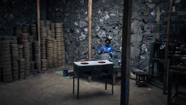 A worker seen at Goma Stove manufactures improved charcoal stoves in Goma. On the hillsides around the capital, there are scarcely any trees left. NGOs and the government are once again trying to respond. The World Wide Fund for Nature (WWF) is trying to minimise the impact of charcoal burning by introducing “eco makala” ovens that burn the fuel more efficiently and so use less wood. (ALEXIS HUGUET / AFP) 