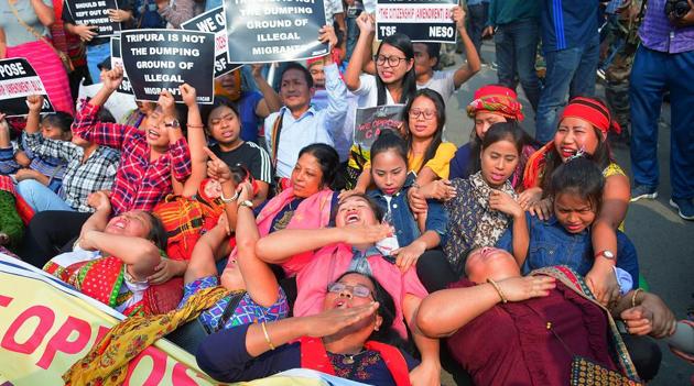 Protesters hold placards and raise slogans against the Citizenship Amendment Bill (CAB), during the shutdown called by North East Students' Organization (NESO), in Agartala on Tuesday.(ANI)