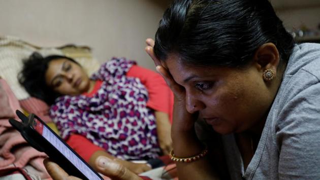 Amritpal Kaur (L) looks at Reena Mehla while she cries remembering her husband. In the past year and a half, the women have managed to suspend more than 400 passports and revoke 67 others, Kabiraj says. In all, more than 5,000 women have filed abandonment complaints with India’s Ministry of External Affairs. The women in his office, Kabiraj says, “have created terror” in several foreign countries. (Anushree Fadnavis / REUTERS)