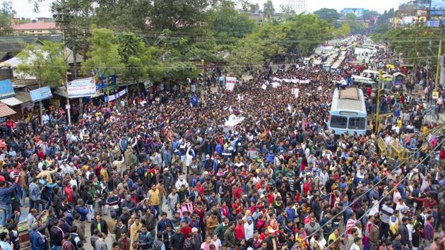 Protestors gather in a street during a protest strike against the Citizenship Amendment Bill (CAB), on the outskirts of Sivasagar town in Assam. Prime Minister Narendra Modi on Thursday assured the people of Assam that he and the central government are committed to constitutionally safeguard the political interests of the Assamese. (PTI)
