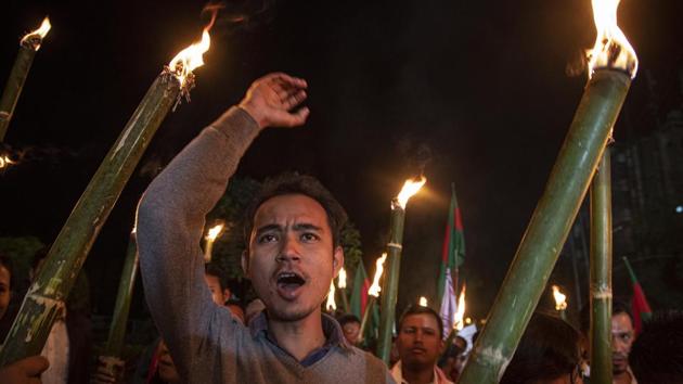 A man shouts slogans as he participates in a torch light procession to protest against the Citizenship Amendment Bill (CAB) in Guwahati. (AP) A man shouts slogans as he participates in a torch light procession to protest against the Citizenship Amendment Bill (CAB) in Guwahati. (AP)