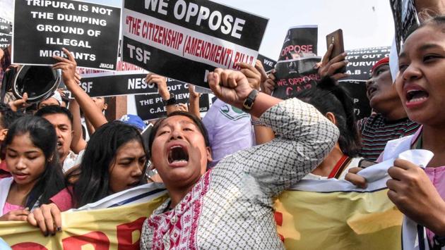 Demonstrators shout slogans as they hold placards to protest against the government's Citizenship Amendment Bill (CAB), during the shutdown in Agartala. After a seven-hour debate, the Rajya Sabha passed the Citizenship (Amendment) Bill, 2019, or CAB. The Lok Sabha had cleared the bill shortly after midnight on Tuesday. It will become law once President Ram Nath Kovind formally gives his assent to the bill. (STR / AFP)