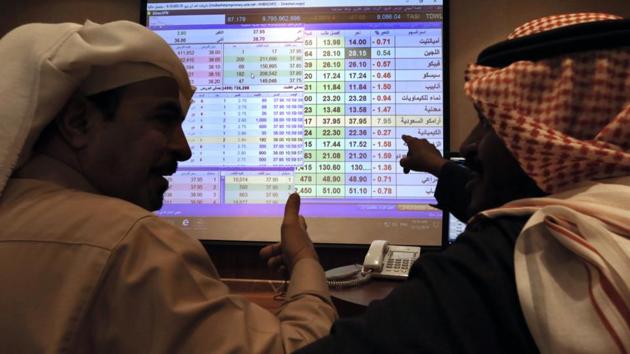 Saudi traders chat as they follow a screen displaying Saudi stock market values at the Arab National Bank in Riyadh, Saudi Arabia, Thursday, Dec. 12, 2019. (AP photo for representation) Saudi traders chat as they follow a screen displaying Saudi stock market values at the Arab National Bank in Riyadh, Saudi Arabia, Thursday, Dec. 12, 2019. (AP photo for representation)