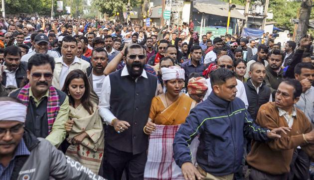 All Assam Students Union (AASU) Chief Advisor Samujjal Bhattacharya along with artists and others raises slogans as they take part in a demonstration against the passing of Citizenship (Amendment) Bill during curfew, at GS Road in Guwahati.(PTI)