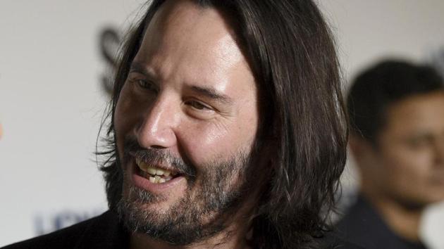 Keanu Reeves, right, and producer Karina Miller speak during in an interview at a special screening of Semper Fi on Tuesday.(Chris Pizzello/Invision/AP)