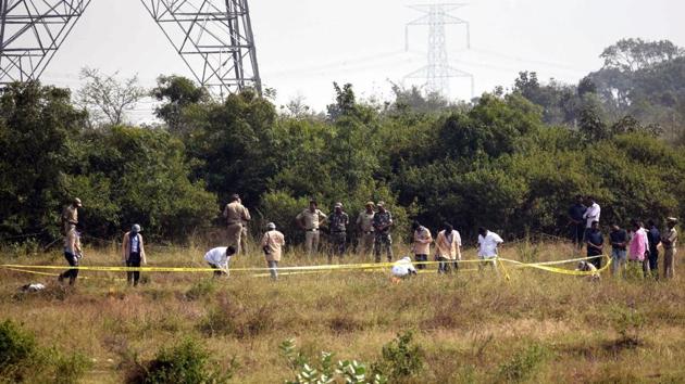 Police officers stand guard at the spot where accused in the rape and murder of the woman veterinarian were killed in an encounter in Hyderabad on Friday. (ANI photo) Police officers stand guard at the spot where accused in the rape and murder of the woman veterinarian were killed in an encounter in Hyderabad on Friday. (ANI photo)