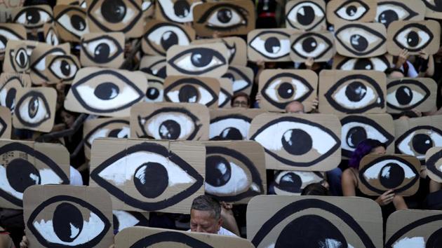Demonstrators hold placards during a protest against Chile's government, in Santiago, Chile. Chile has been rocked by nearly two months of chaos and protests over inequality and social injustices. Rioting has left 26 dead, billions in damages and widespread allegations of abuse, torture and rape by security forces. (Pablo Sanhueza / REUTERS)