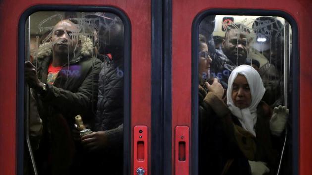 Passengers fill a metro train at the Gare du Nord RER station during a strike by all unions of the Paris transport network (RATP) and French SNCF workers in Paris as part of a second day of national strike and protests in France. (Eric Gaillard / REUTERS)