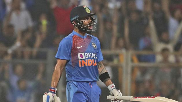 India's captain Virat Kohli reacts after hitting six runs during the third Twenty20 international match between India and West Indies in Mumbai.(AP)