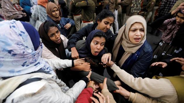 Police detain a protester outside Jamia Millia Islamia University during a protest against the Citizenship Amendment Bill, in New Delhi. (Adnan Abidi / REUTERS)