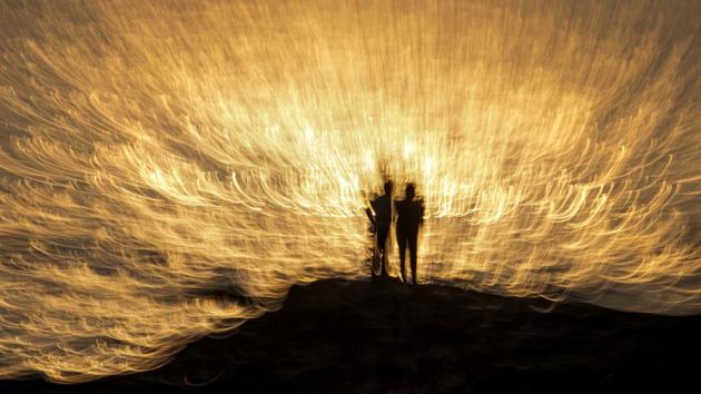 People seen at Bandra sea shore with dramatic evening light in Mumbai. (Satish Bate / HT Photo)