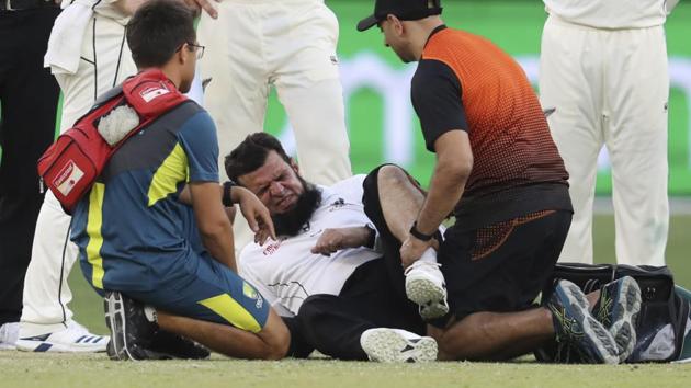 Umpire Aleem Dar is attended to by medical staff.(AP)