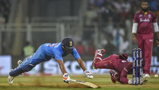 Rohit Sharma dives to complete a run during the third T20 cricket match against West Indies, at Wankhede Stadium in Mumbai. (Mitesh Bhuvad / PTI)