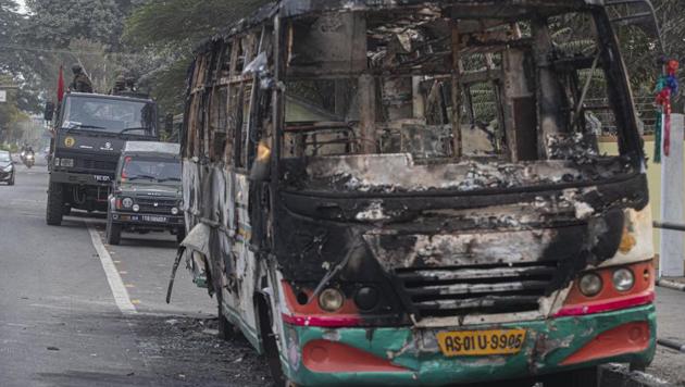 Army vehicles parked behind a bus which was burnt by protesters during a protest against the Citizenship Amendment Bill in Assam on Friday. (AP Photo) Army vehicles parked behind a bus which was burnt by protesters during a protest against the Citizenship Amendment Bill in Assam on Friday. (AP Photo)