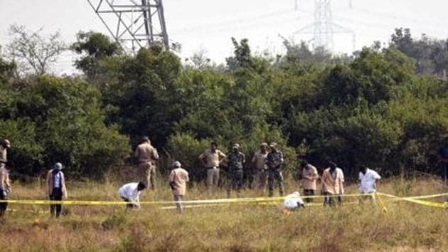 Police officers stand guard at the spot where the four men accused in the rape and murder of the woman veterinarian were killed in an encounter in Hyderabad.(STYLE PHOTO SERVICE.) Police officers stand guard at the spot where the four men accused in the rape and murder of the woman veterinarian were killed in an encounter in Hyderabad.(STYLE PHOTO SERVICE.)