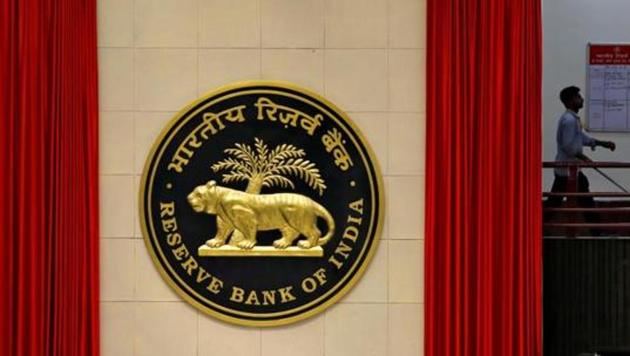 A worker walks past the logo of Reserve Bank of India (RBI) inside its office in New Delhi, India July 8, 2019. REUTERS/Anushree Fadnavis/Files (Reuters File Photo)