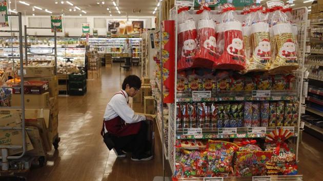 An employee stocks shelves at a newly opened Aeon supermarket in Namie. The word Fukushima has become globally known, but regrettably the situation in Futaba or (neighboring) Okuma is hardly known,” Izawa said, noting Futaba’s recovery won’t be ready by the Olympics. “But we can still show that a town that was so badly hit has come this far,” he added. (Jae C. Hong / AP)