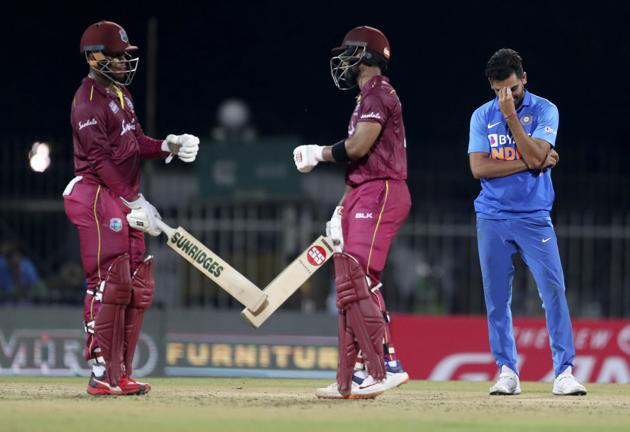 Deepak Chahar, right, reacts as West Indies' Shimron Hetmyer, left, and batting partner Shai Hope celebrate scoring runs. (AP)