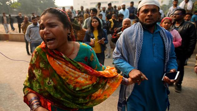 A family member of a worker mourns after the fire at a factory at Anaj Mandi took at least 43 lives, at Lok Nayak Jai Prakash Narayan (LNJP) Hospital, in New Delhi. The five-storey building that caught fire on December 8, leaving 43 workers dead, was not just an illegal factory without requisite clearances; a series of violations made the establishment a dangerous fire hazard, according to the initial findings of the Delhi Police crime branch. (Amal KS / HT Photo)